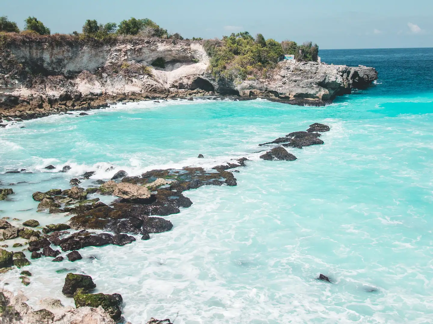 Turquoise cove with rocks and cliffs on the coast of Bali