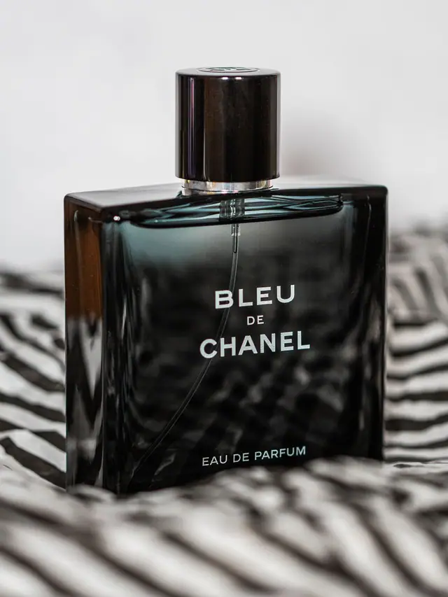 Bleu de Chanel Eau de Parfum bottle on striped black-and-white fabric